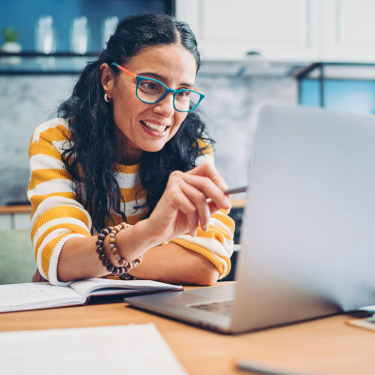 Woman working on a laptop.