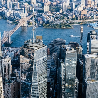 Aerial view of New York City skyscrapers with the Brooklyn Bridge and East River in the background. Aerial view of New York City skyscrapers with the Brooklyn Bridge and East River in the background.