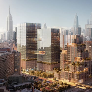 Rendering of SPARC Kips Bay. Aerial view of New York City featuring several high-rise glass buildings. The sun casts a warm glow, reflecting off the structures. In the background, a skyline of taller skyscrapers is visible against a hazy sky.