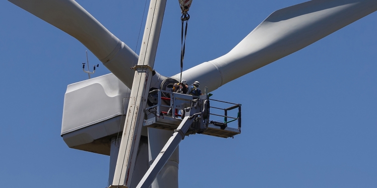 Two people conducting wind turbine maintenance
